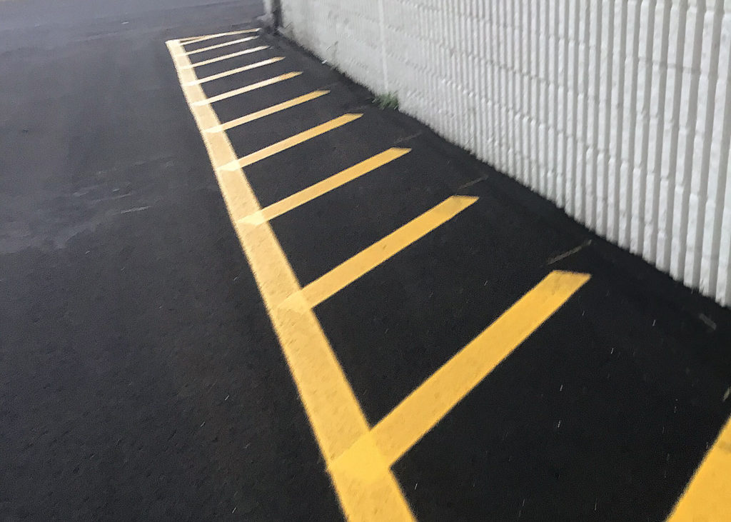 Yellow no parking lines on an asphalt truck stop parking lot in North Carolina.