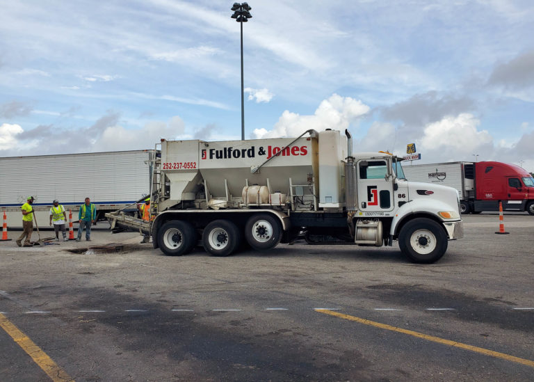 Fulford & Jones Asphalt, Inc. uses a volumetric concrete mixer to place concrete for utility work at Kenly 95 Truckstop in Kenly, NC.