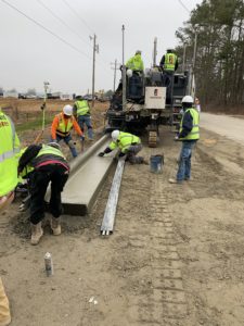 Workers hand finish a new concrete curb near a new construction site in Wendell, NC.