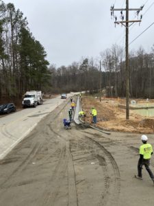 A concrete crew finishes a newly placed concrete curb at a new development in Wendell, NC.