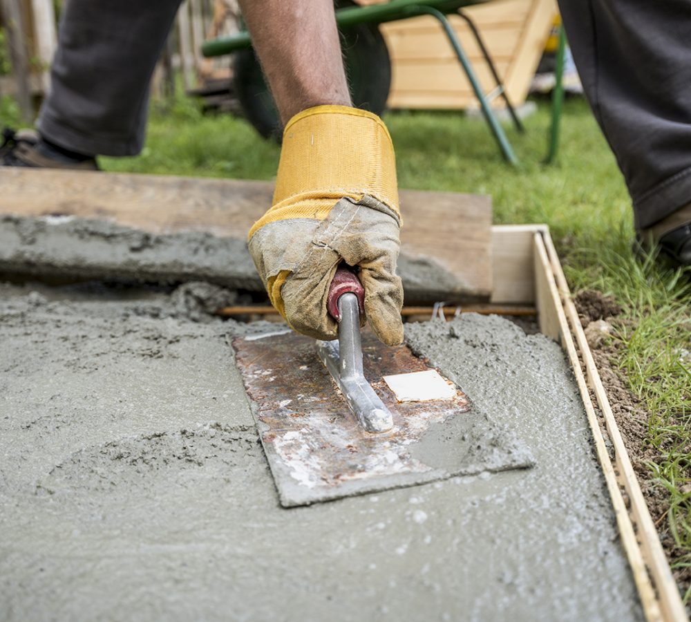 Close up on paver smoothing fresh concrete